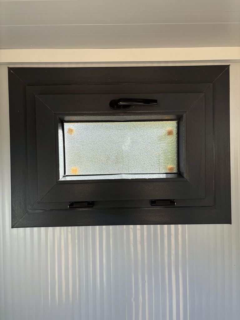 Window of a portable handicap toilet unit.