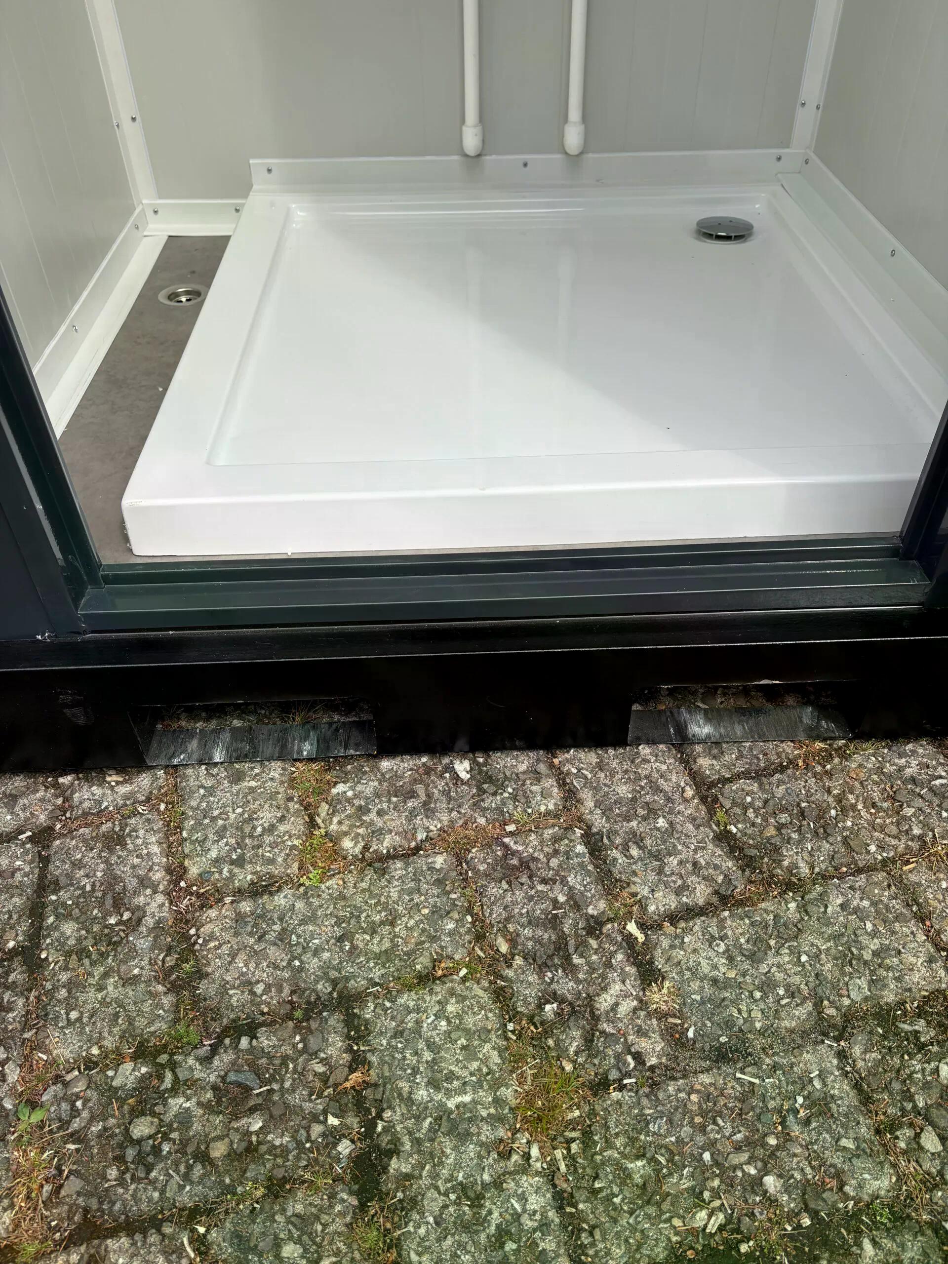 Doorstep of a dual portable shower unit.