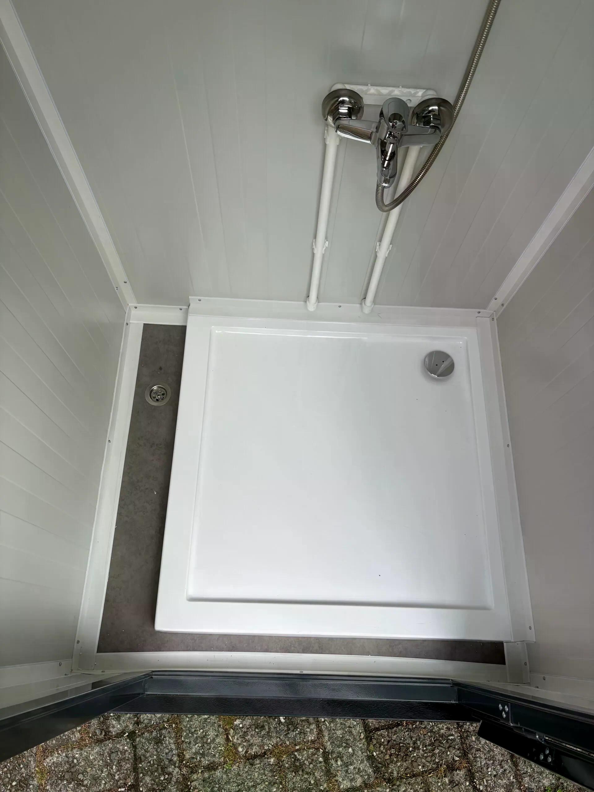 Floor of a dual portable shower unit.