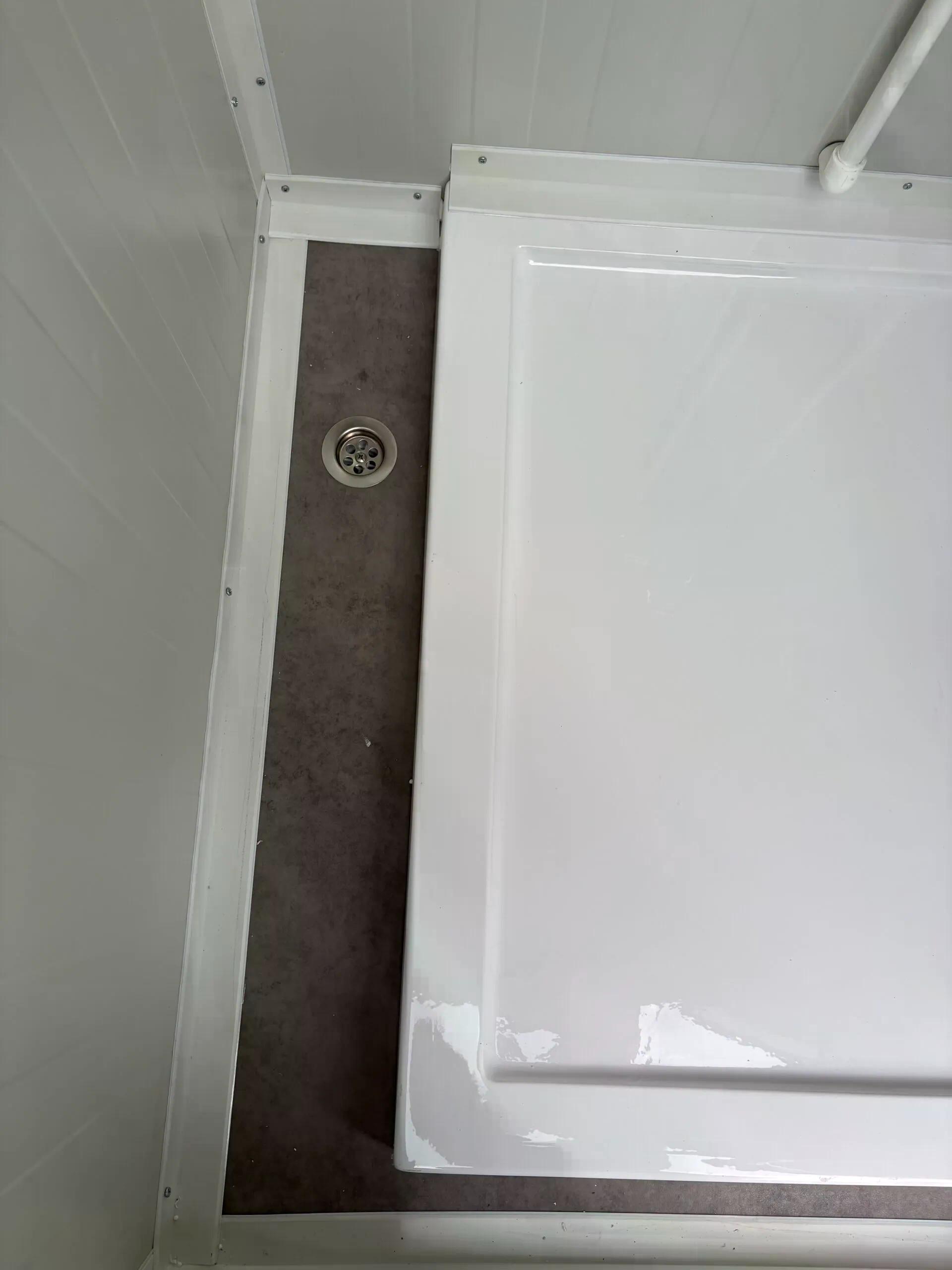 Floor drainage system of a dual portable shower unit.